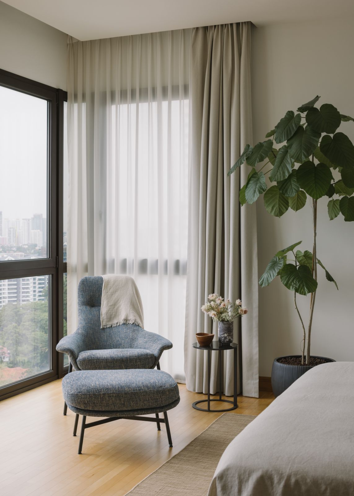 This cosy reading corner—framed by soft drapery and leafy greens—offers a serene perch for quiet moments and gentle introspection