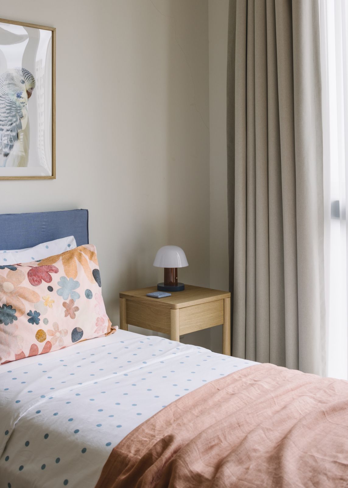 Soft light, whimsical textiles and simple wooden accents come together to create a space that feels both playful and serene