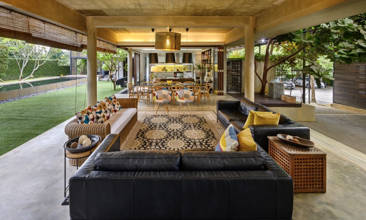 The open-plan living space at Denai House embodies Razin Mahmood's approach to tropical modernism, seamlessly connecting indoor and outdoor areas while incorporating natural ventilation and cultural considerations