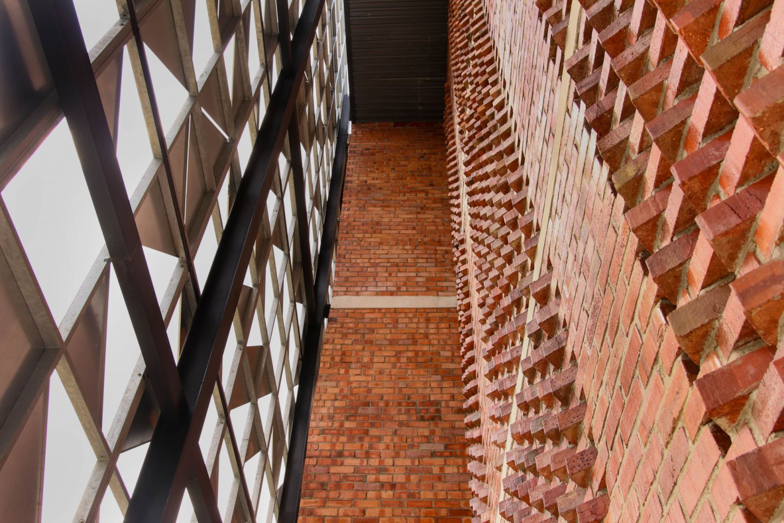 The intricate brickwork and geometric screening of Masjid Daing Abdul Rahman demonstrate how traditional Islamic symbolism can be expressed through modern construction techniques