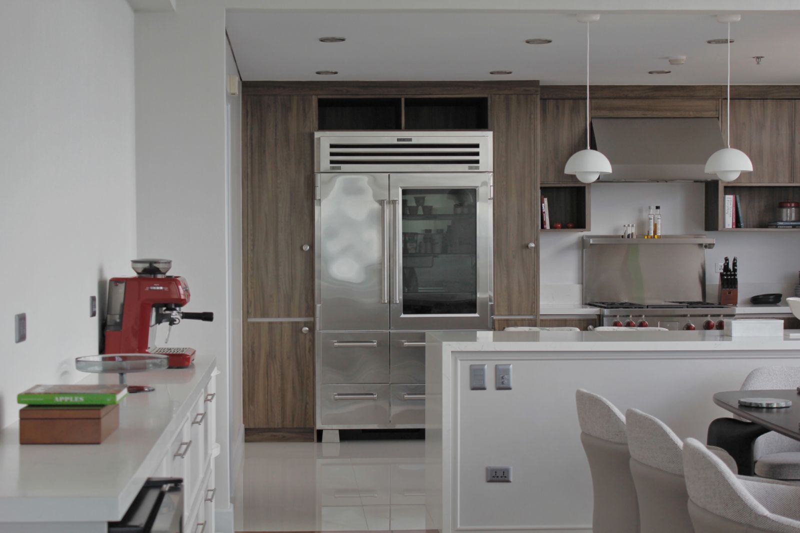 The dining area leading into the kitchen of a Makati penthouse apartment