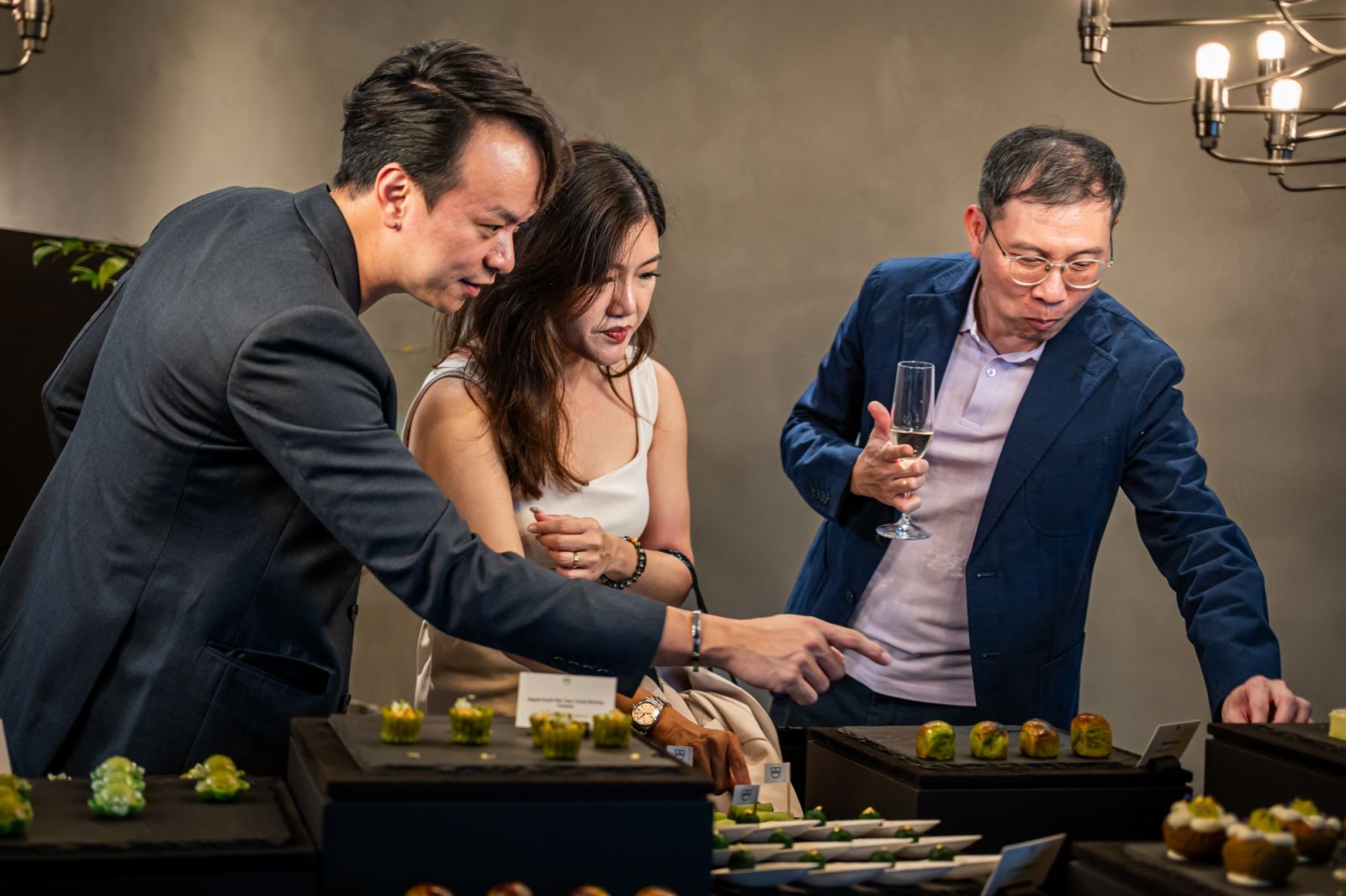 Guests enjoying the green-themed canapes
