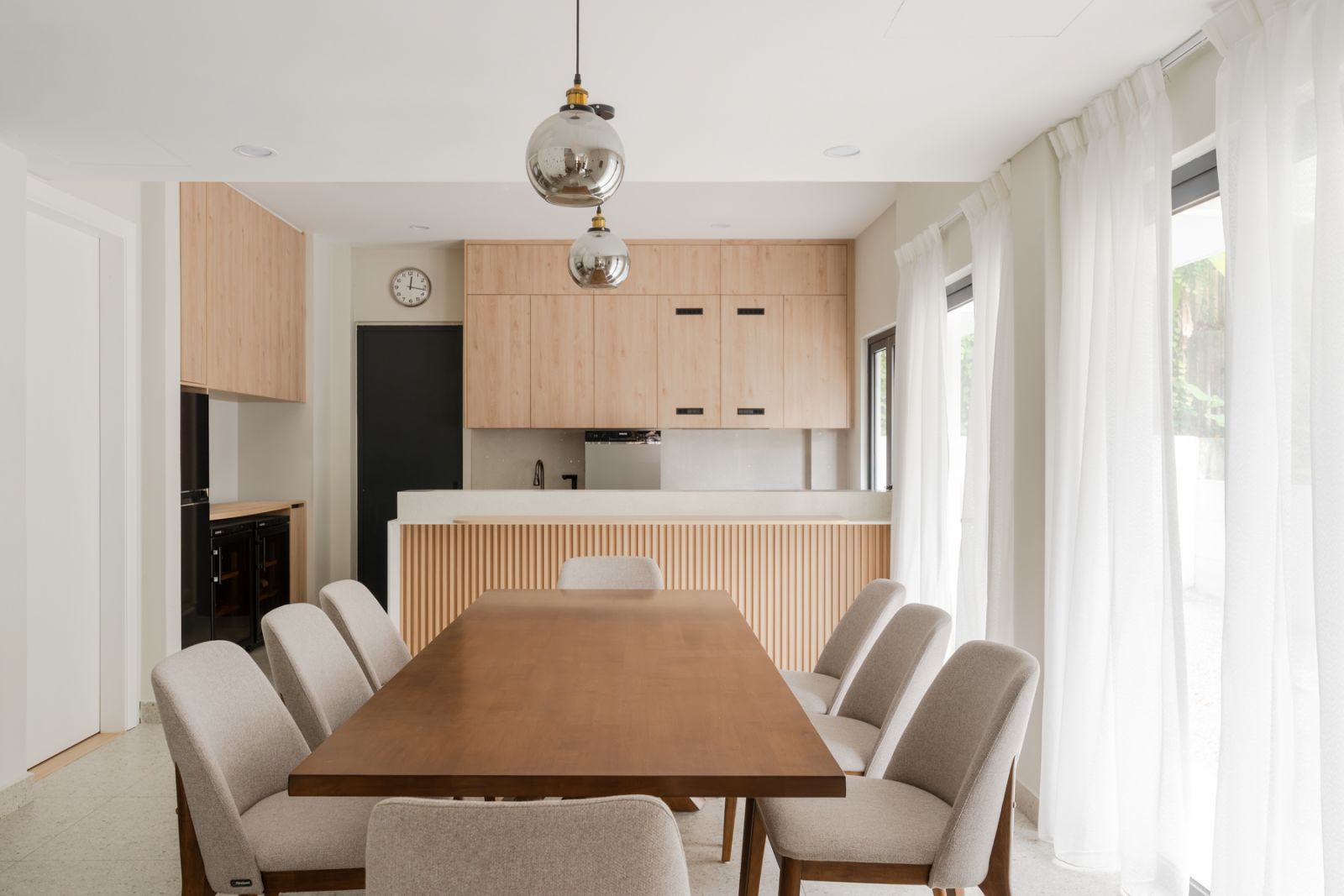 Minimalist elegance defines the dining area, where clean lines and natural light create a serene gathering space