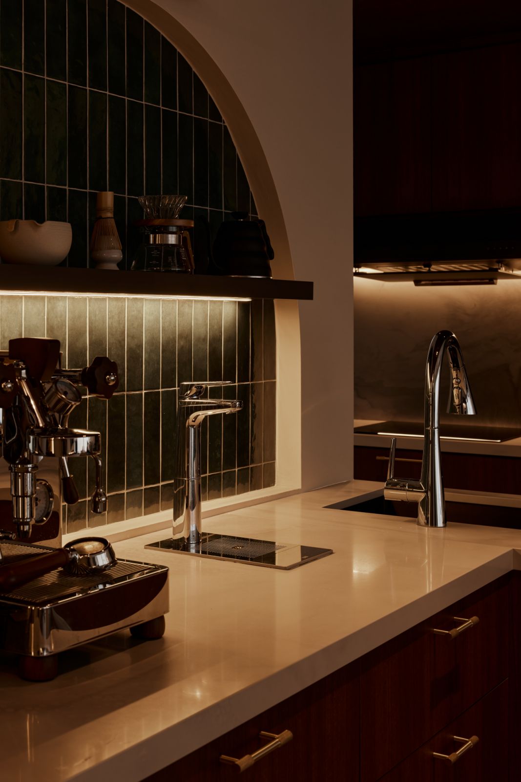 Seen at dusk, the home glows with a quiet intimacy, where indirect lighting enhances texture and brings depth to every surface