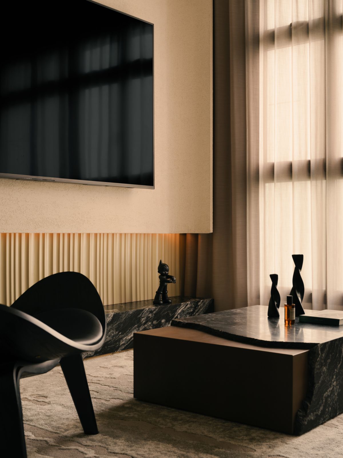 A refined material palette of cream, black and marble sets the tone for a moody yet tactile living experience in this LA Design Studio project