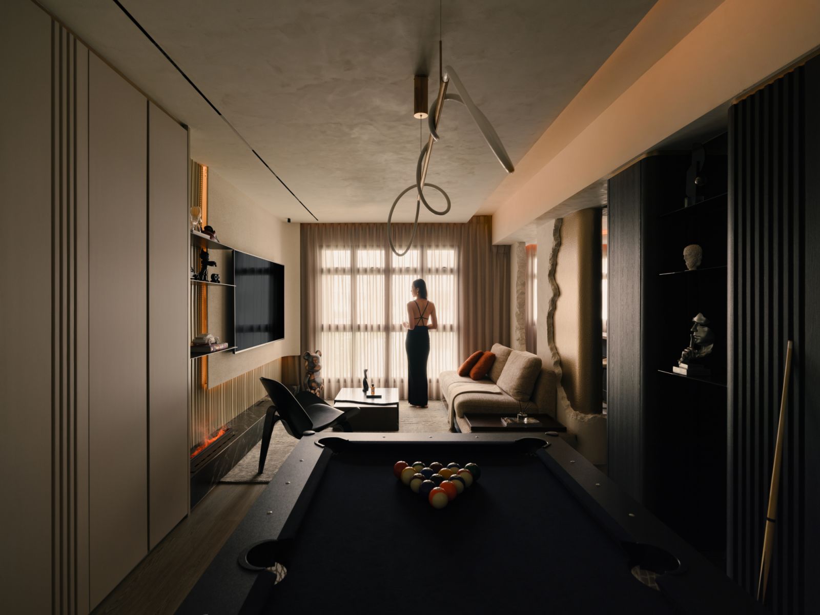 Designed for entertaining, the open-plan layout transitions seamlessly from living to leisure, anchored by warm lighting and expressive furniture