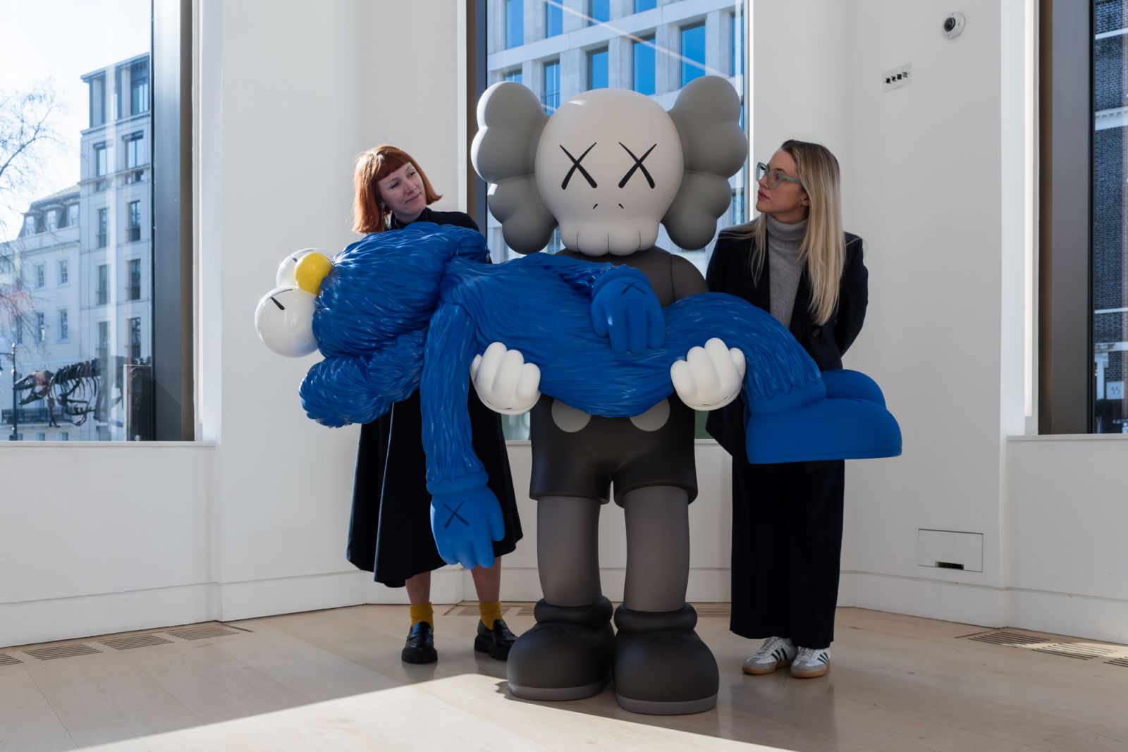 LONDON, UNITED KINGDOM - FEBRUARY 28, 2025: Staff members look at "GONE" by KAWS, estimate: £600,000 - 800,000 during a photocall at Phillips auction house showcasing the highlights from Modern & Contemporary Art Auctions in London, United Kingdom on February 28, 2025. (Photo credit should read Wiktor Szymanowicz/Future Publishing via Getty Images)