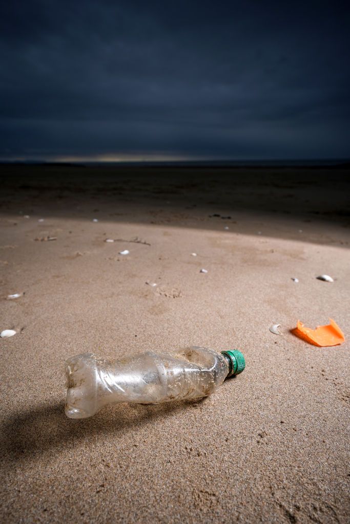PRESTATYN, UNITED KINGDOM - APRIL 22: A plastic bottle and the remains of a child's spade lay on the beach on Earth Day in North Wales on April 22, 2024 in Prestatyn, United Kingdom. Earth day was first held on April 22, 1970 and has grown to incorporate 193 countries globally. The official theme for 2024 is "Planet vs. Plastics." (Photo by Christopher Furlong/Getty Images)