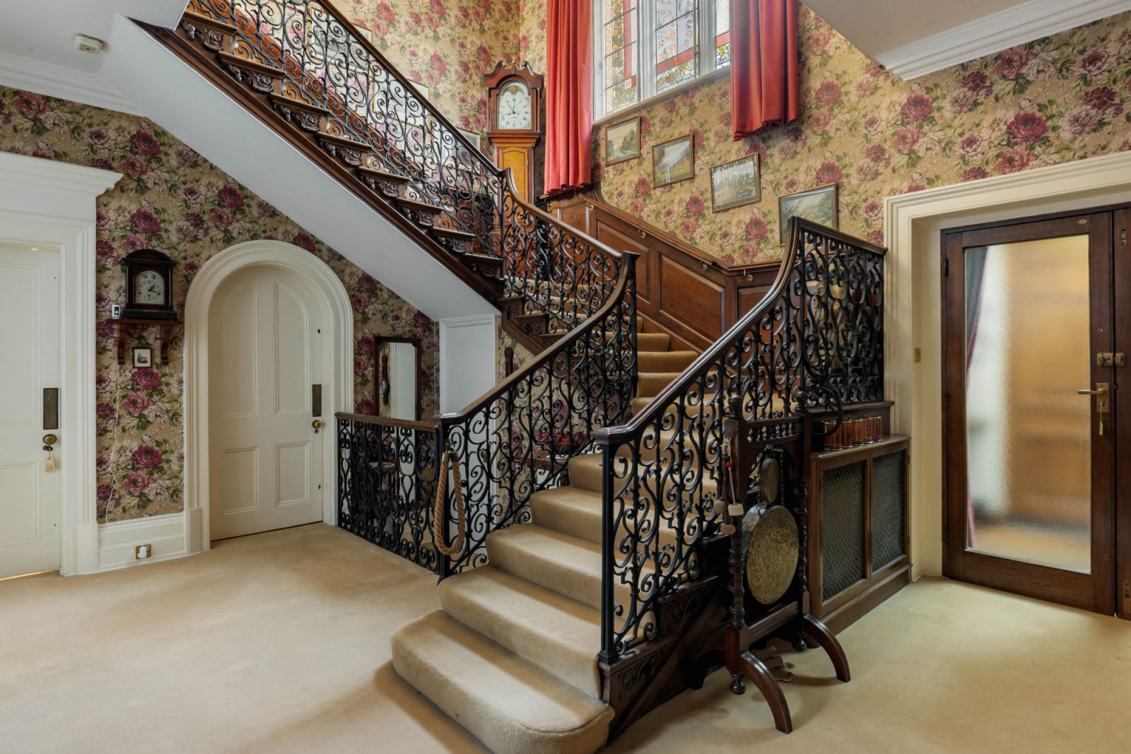 An impressive ornate staircase leads to the first floor