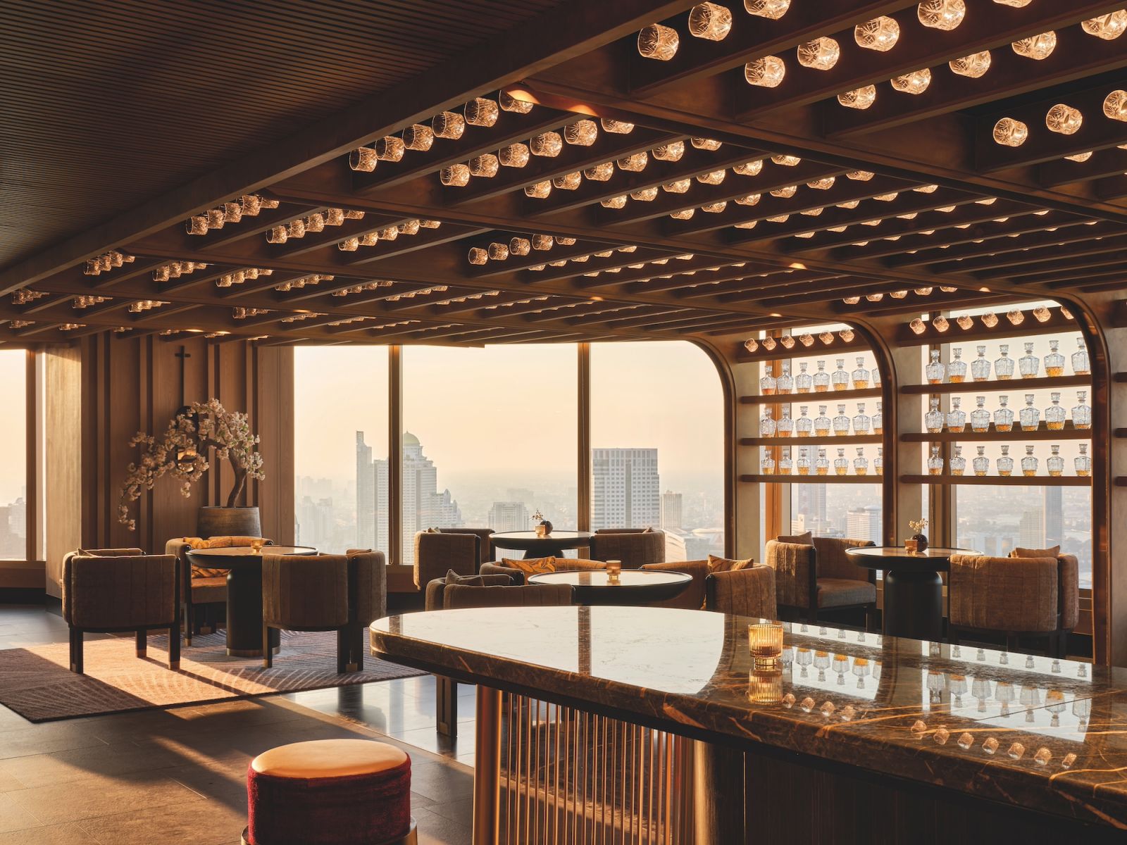 The whiskey bar at Nobu Bangkok draws inspiration 
from traditional Thai architecture, featuring tiered ceiling elements that mirror the country’s iconic roof structures (Photo: Owen Raggatt)