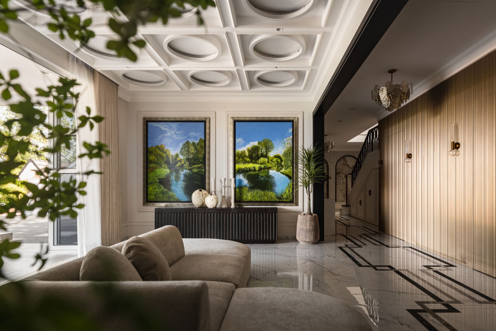 Utilising the  “compress and release” design principle, the home  features lower ceilings  at entry points that open dramatically into lofty spaces, maximising the emotional impact of its interior volumes