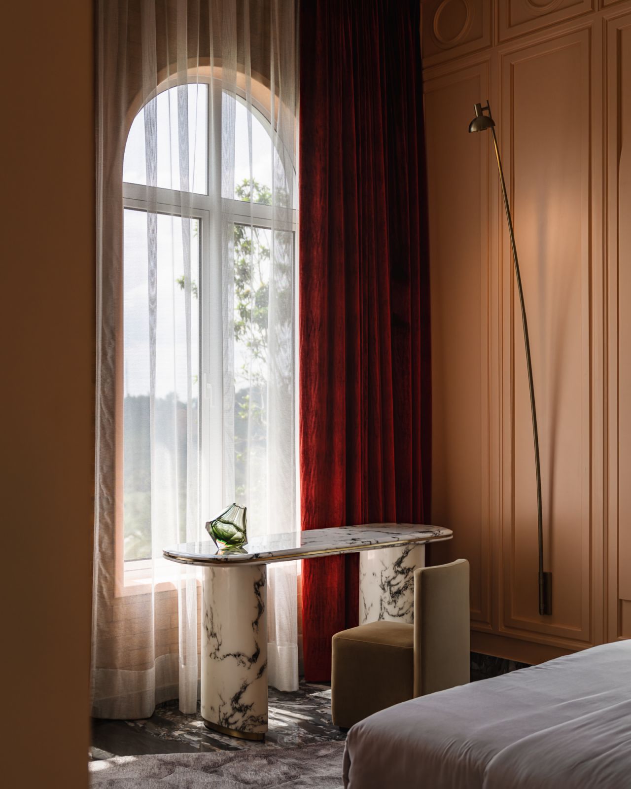 A marble table anchors the space, its natural veining adding subtle texture