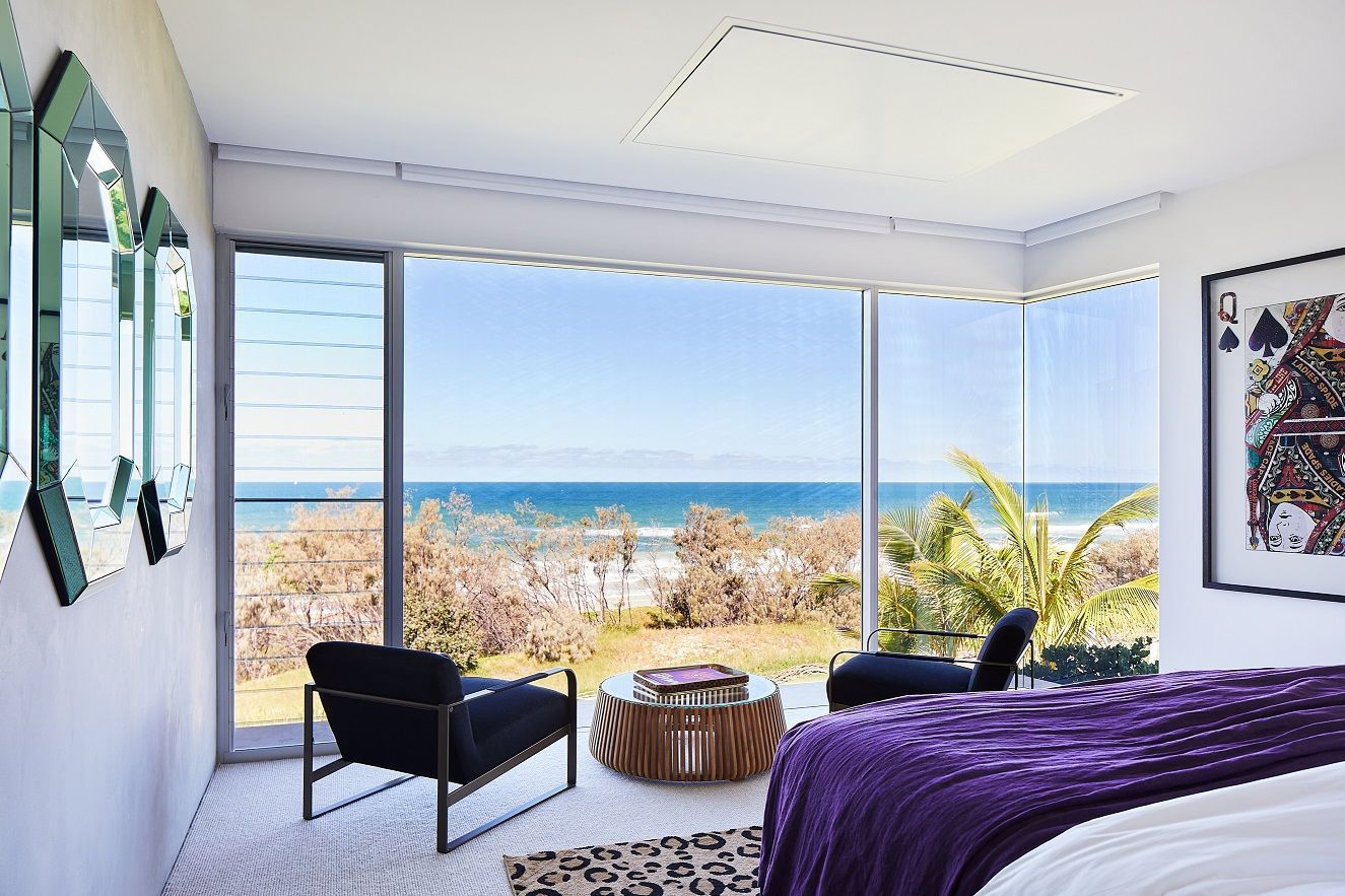 Floor-to-ceiling windows in the bedroom frame the scenic vista (Photo: Alicia Taylor)