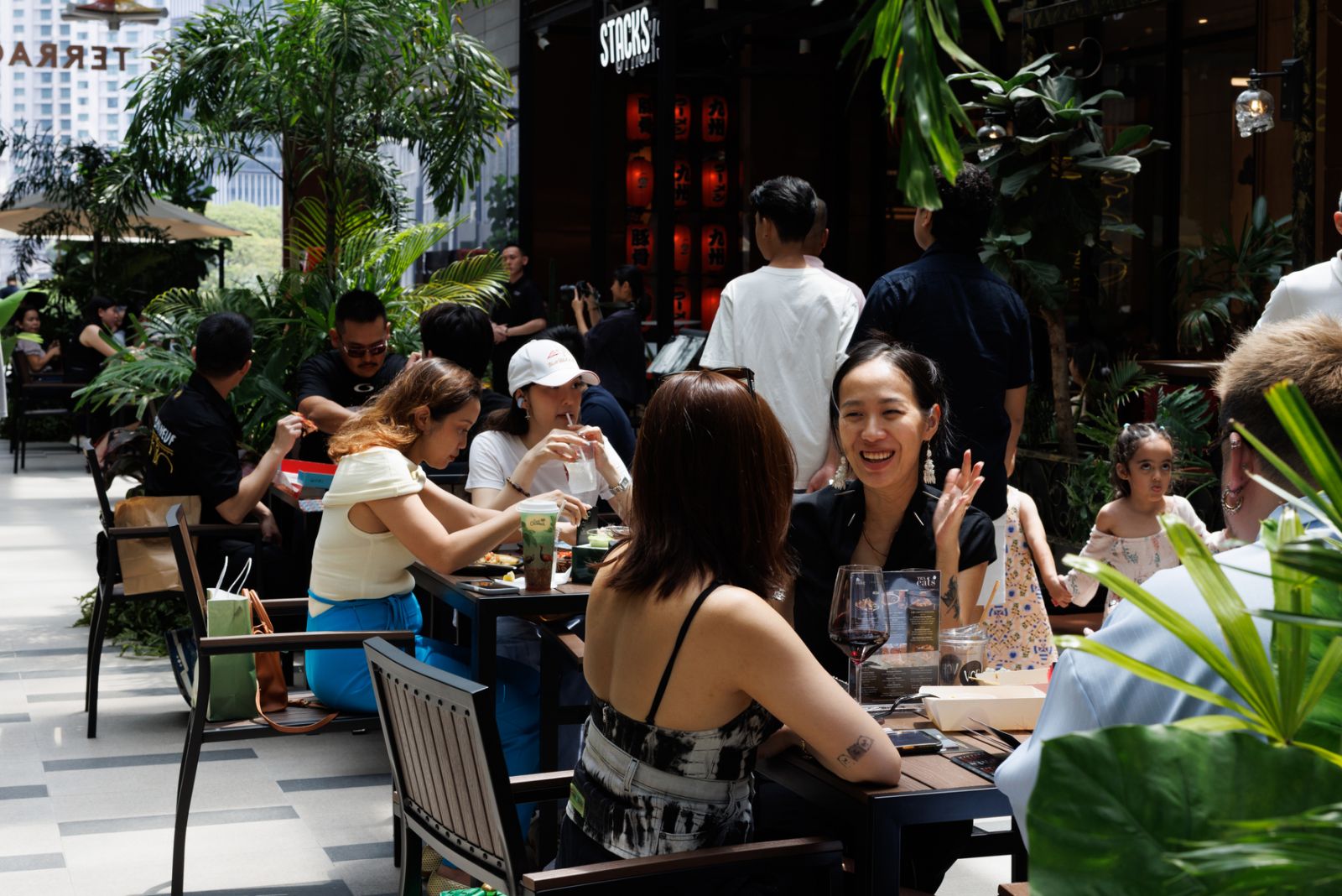 The vibrant setting of the Big Brunch, with guests sitting and eating al fresco