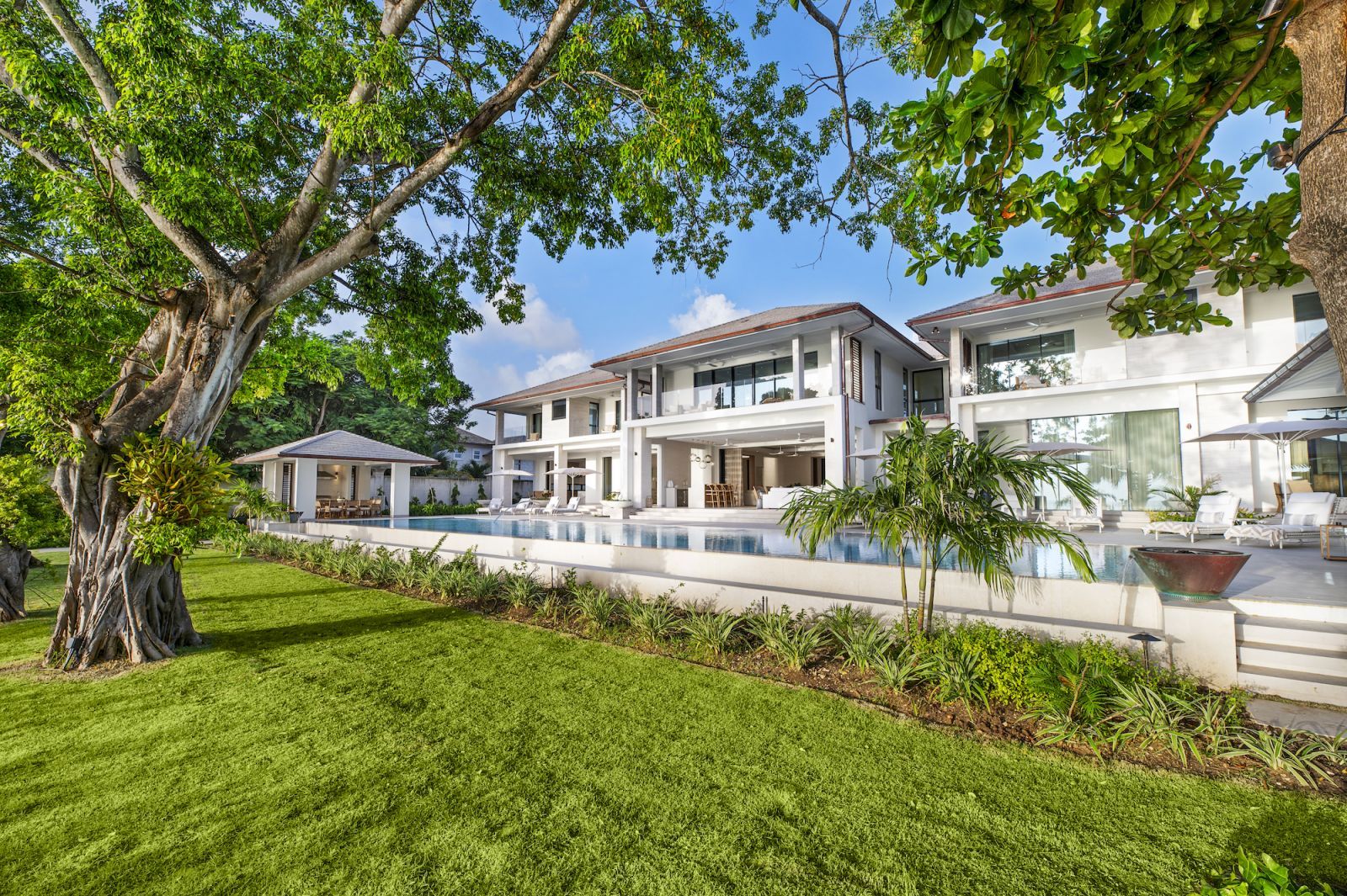 One Beachlands features an infinity pool amidst lush landscaping (Photo: One Caribbean Estates)