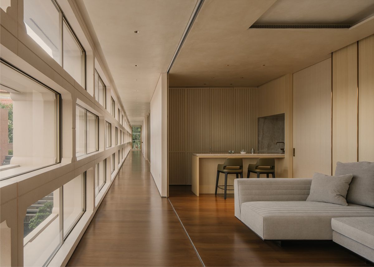 The bedroom suites are arranged in a linear format, with each featuring a lounge with a curtain wall to the corridor