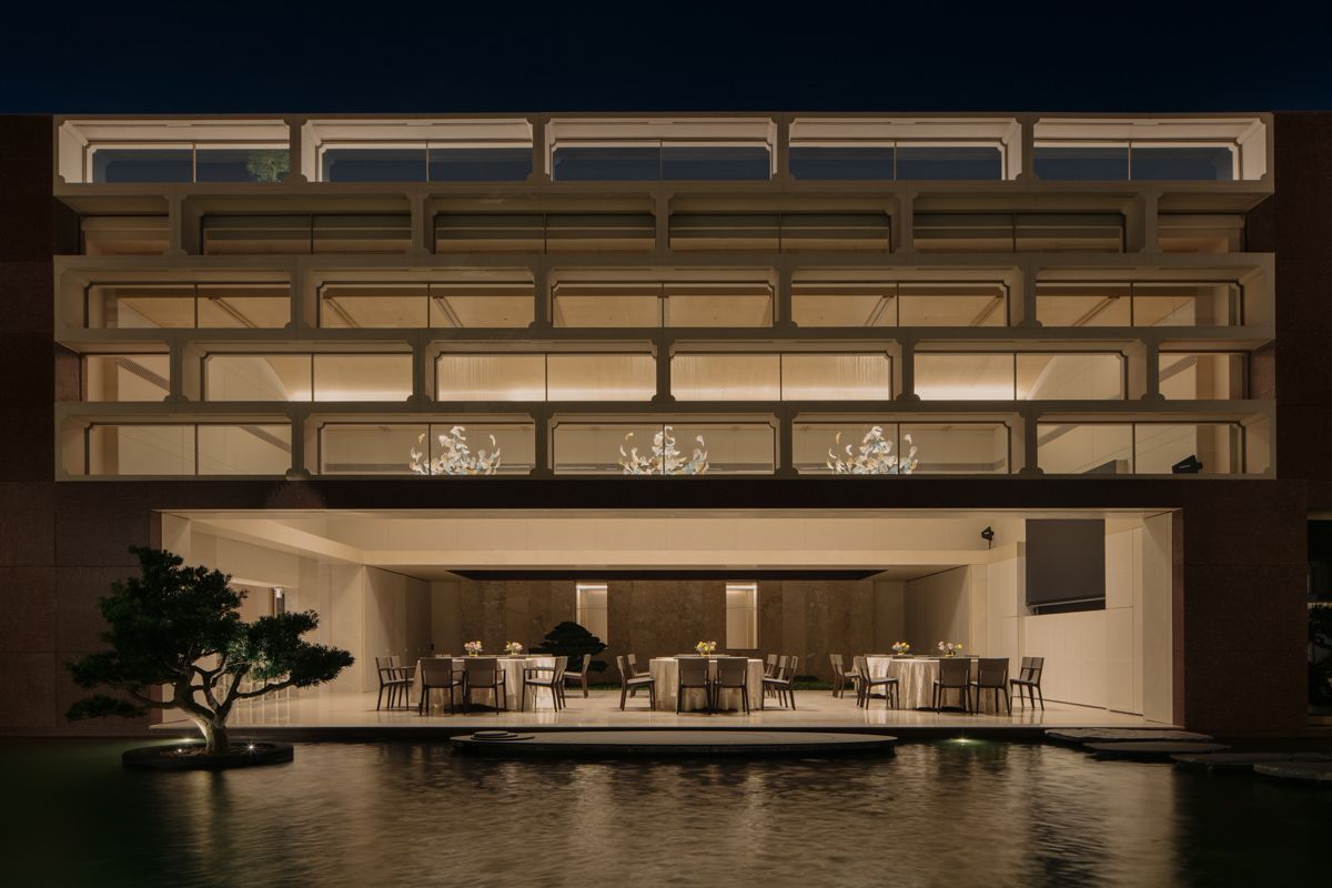 An evening view of the Moongate House’s banquet hall from the bridge