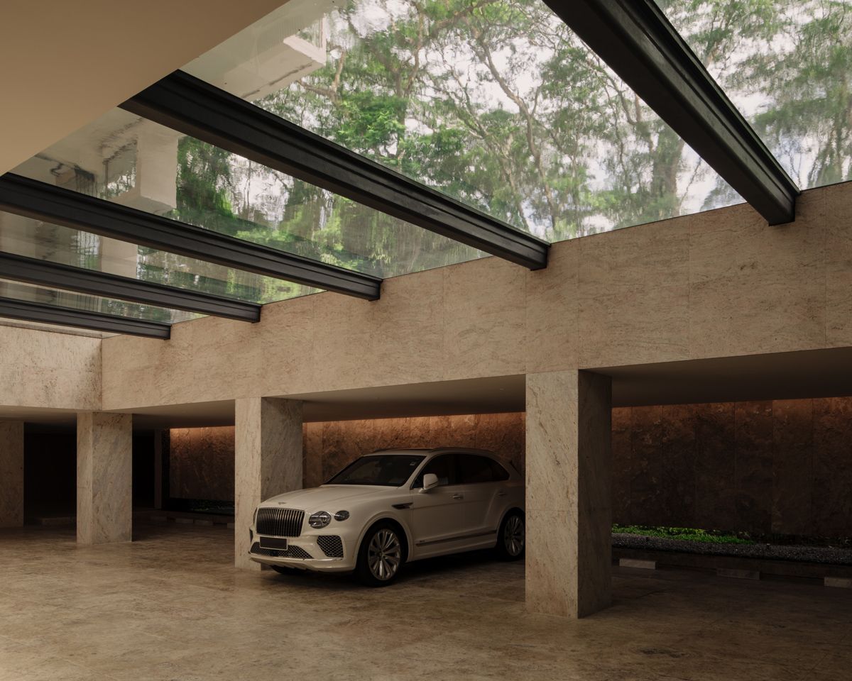 The ground-floor pool does double duty as a skylight for the basement car park