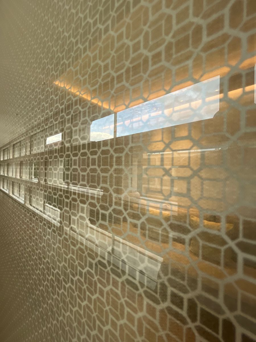 The screen along the corridor leading to the bedroom lounge