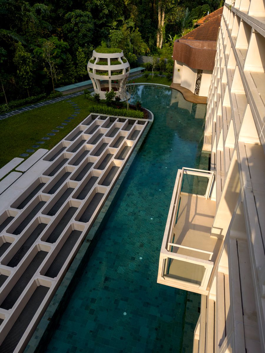 A bird’s-eye view of the Moongate House’s swimming pool and the basement skylight from the attic balcony