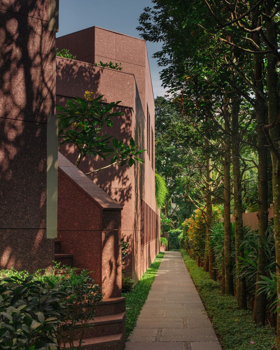 Tall trees shade the pathway that encircles the property