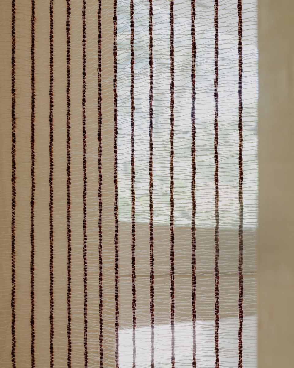 Screens at the living room filters the light poetically