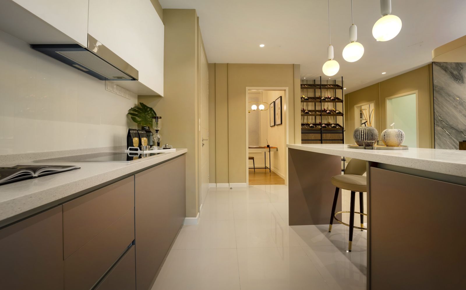 The kitchen features sleek handle-less cabinetry in warm grey and marble-effect countertops extending to form a breakfast bar