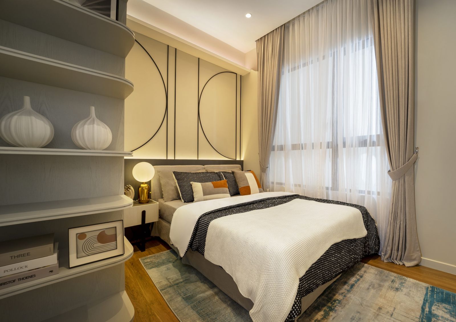 The neutral palette with orange accents maintains visual continuity across all rooms while providing flexible living arrangements for contemporary family needs