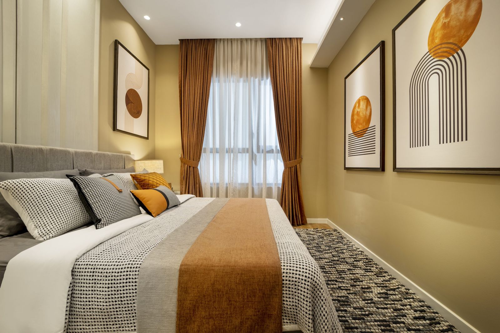 The neutral foundation of grey and cream allows the strategic orange elements to create character without overwhelming the restrained design approach.