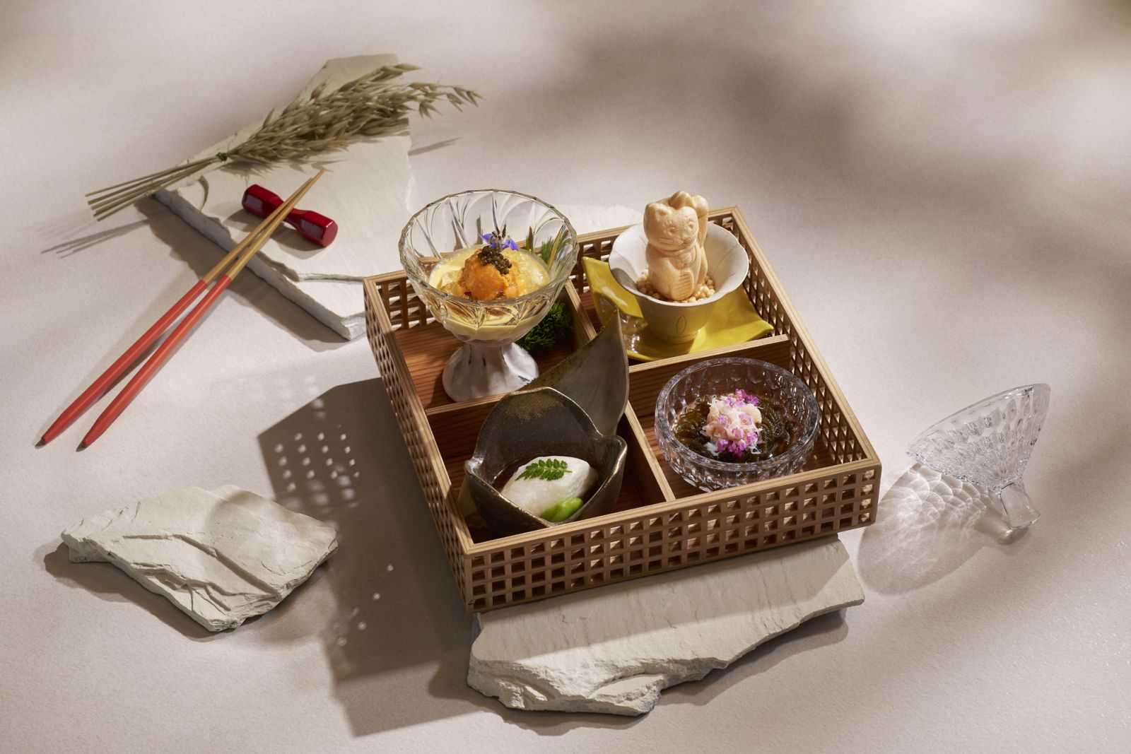 A quartet of appetisers in a traditional kaiseki presentation, blending textures and temperatures with playful precision