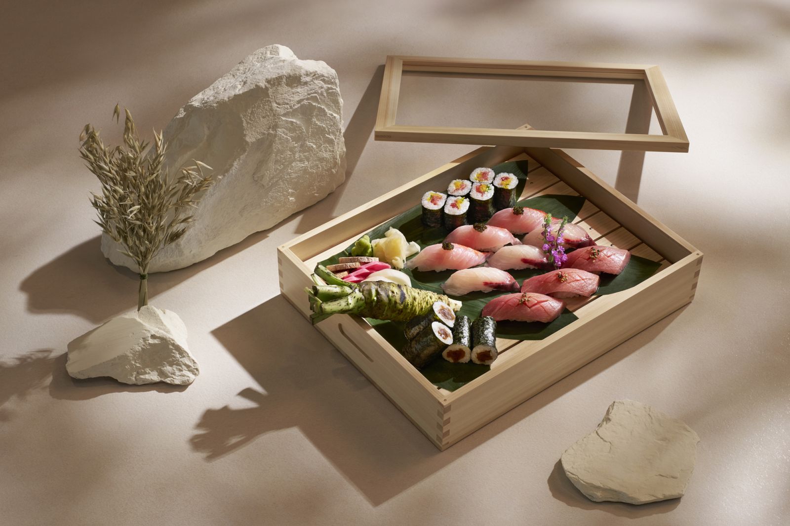 An assortment of seasonal nigiri and maki, elegantly presented in a wooden box
