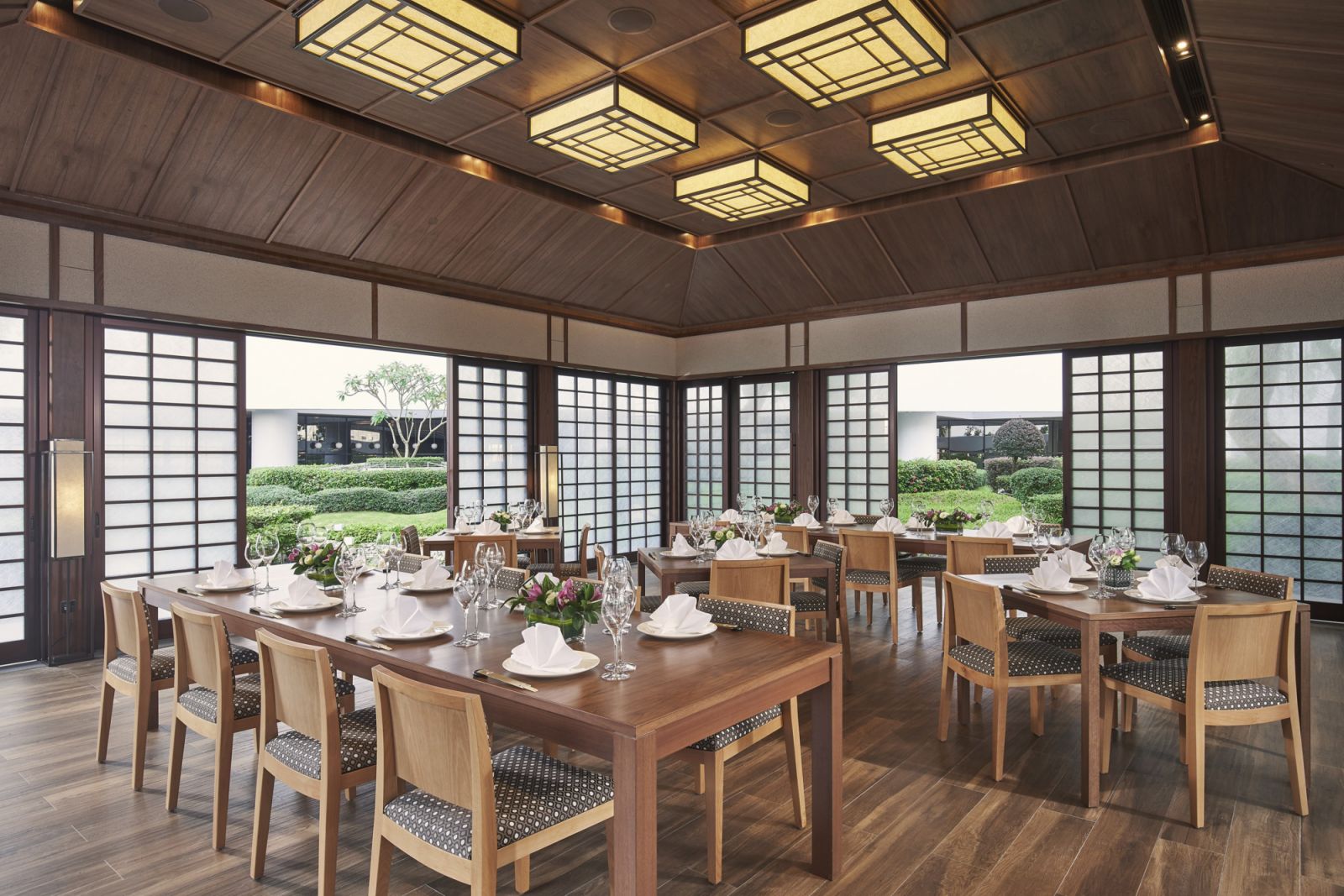 Inside the garden pavilion, shoji screens and soft natural light frame a dining experience that’s as elegant as it is immersive