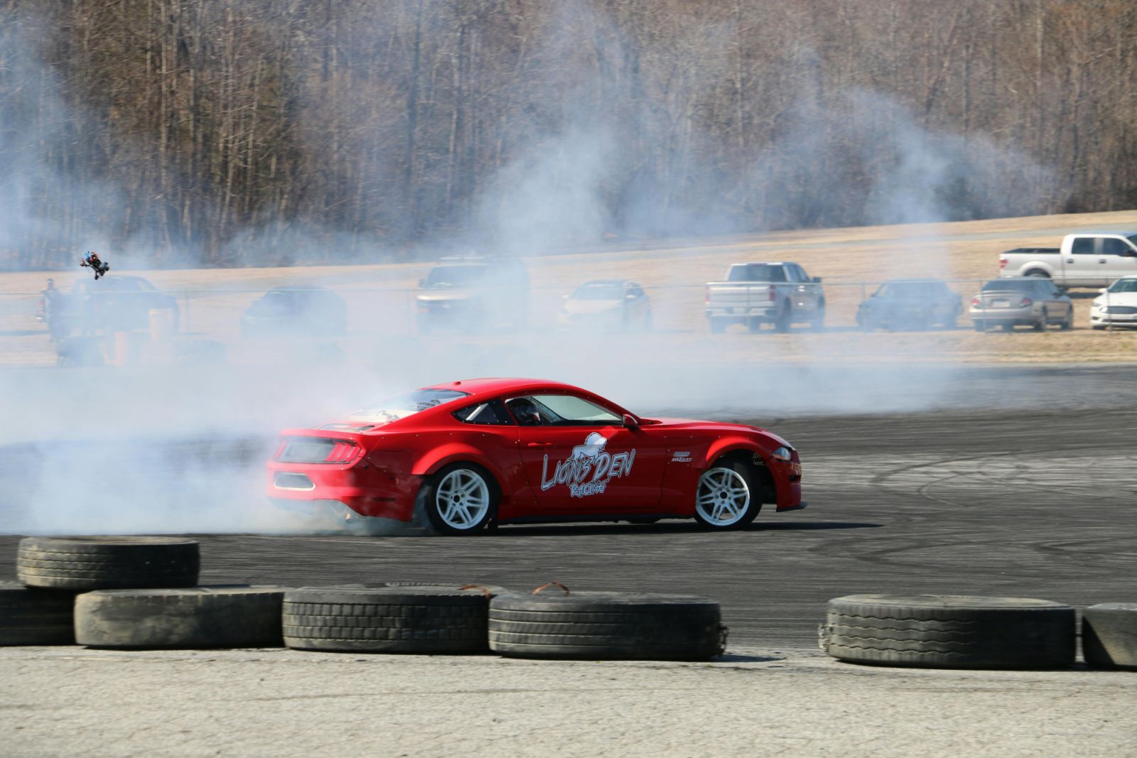 Red car drifting on a grey asphalt race track (Photo: Pexels / Jaxon Matthew Willis)