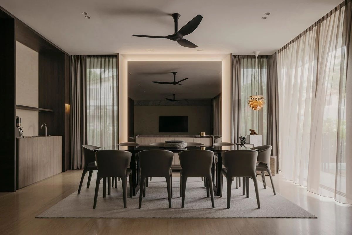 The Bukit Timah landed home's dining room features a pleasing symmetry anchored by a mirrored wall that doubles the perception of the space