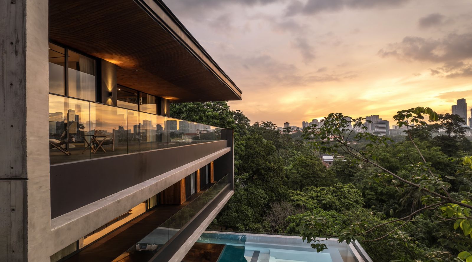 The board-form concrete walls treated with timber-strip shuttering technique add tactile depth to the modernist facade while preserving mature trees below