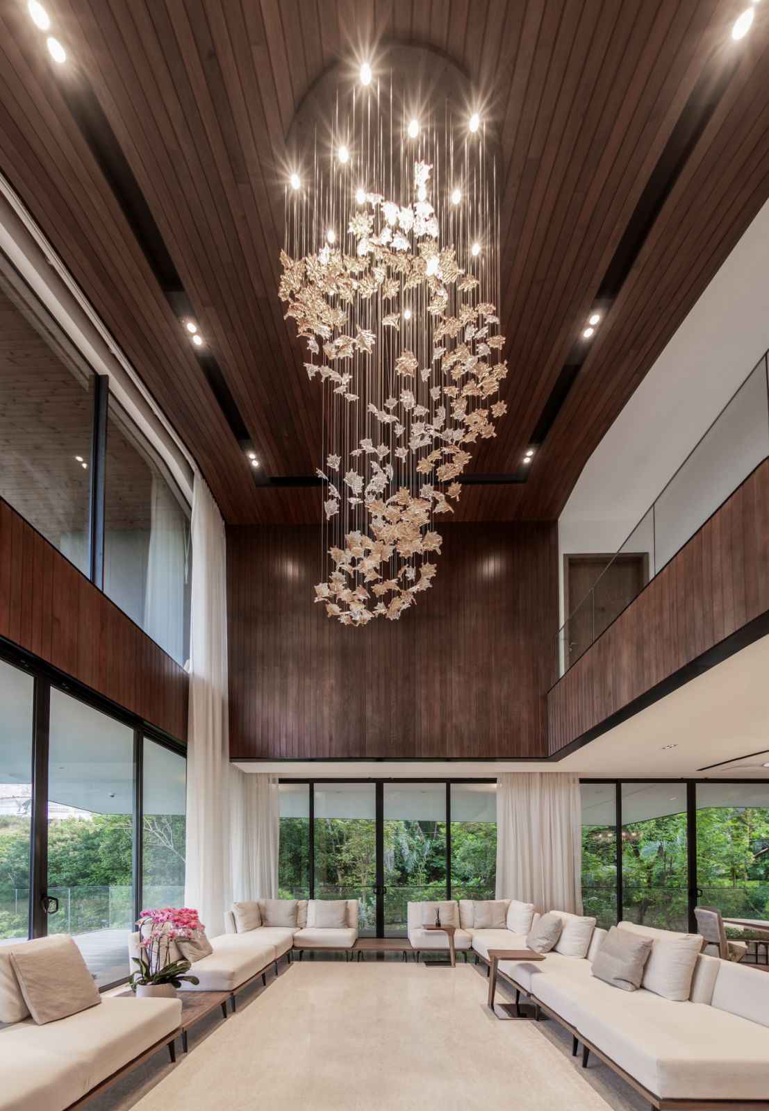 Soaring double-height ceilings and full-height glazing transform the living area into a cathedral of light