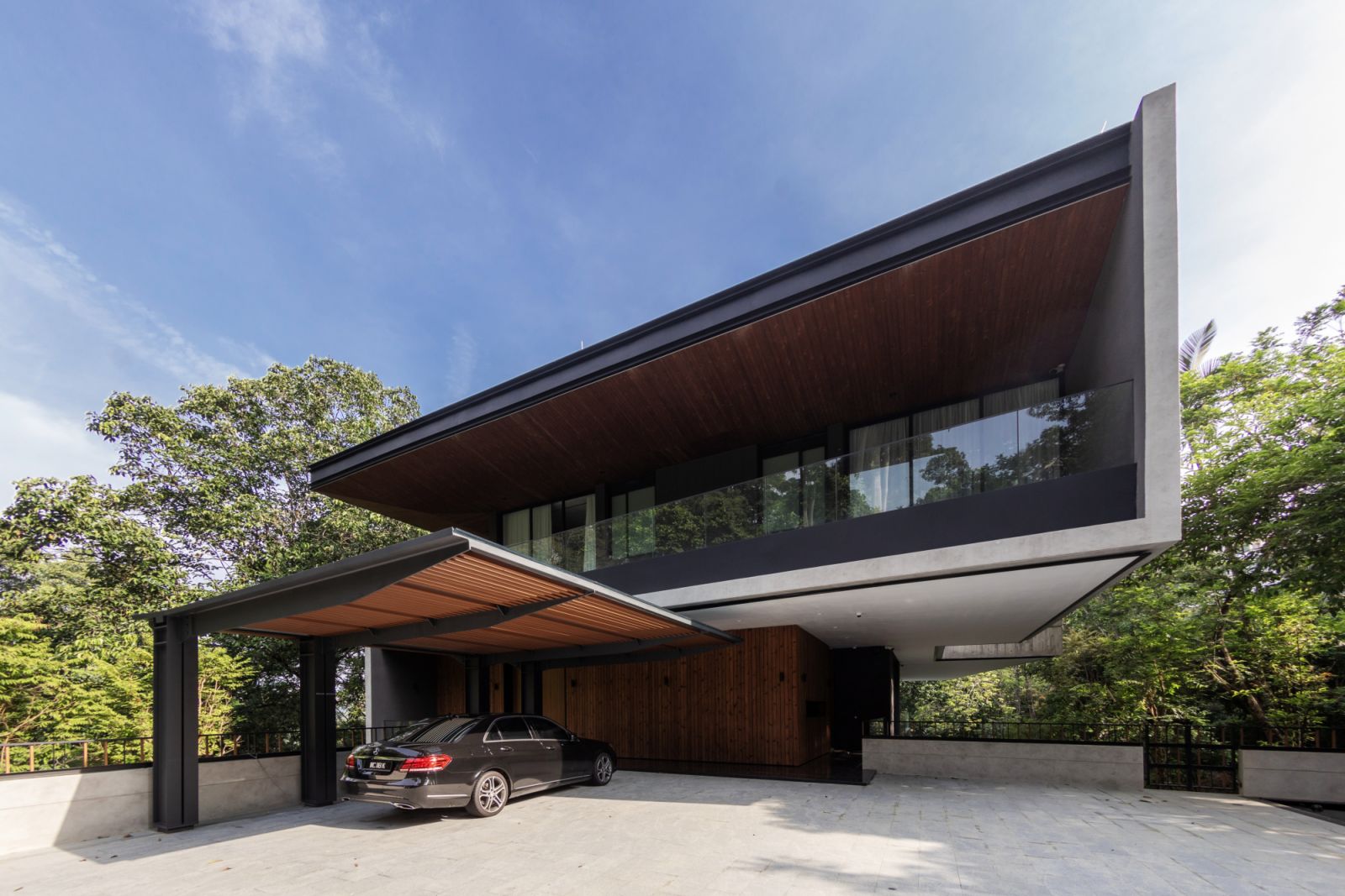 The entrance of the home is relatively modest compared to the full expanse of the complete residence on the reverse side