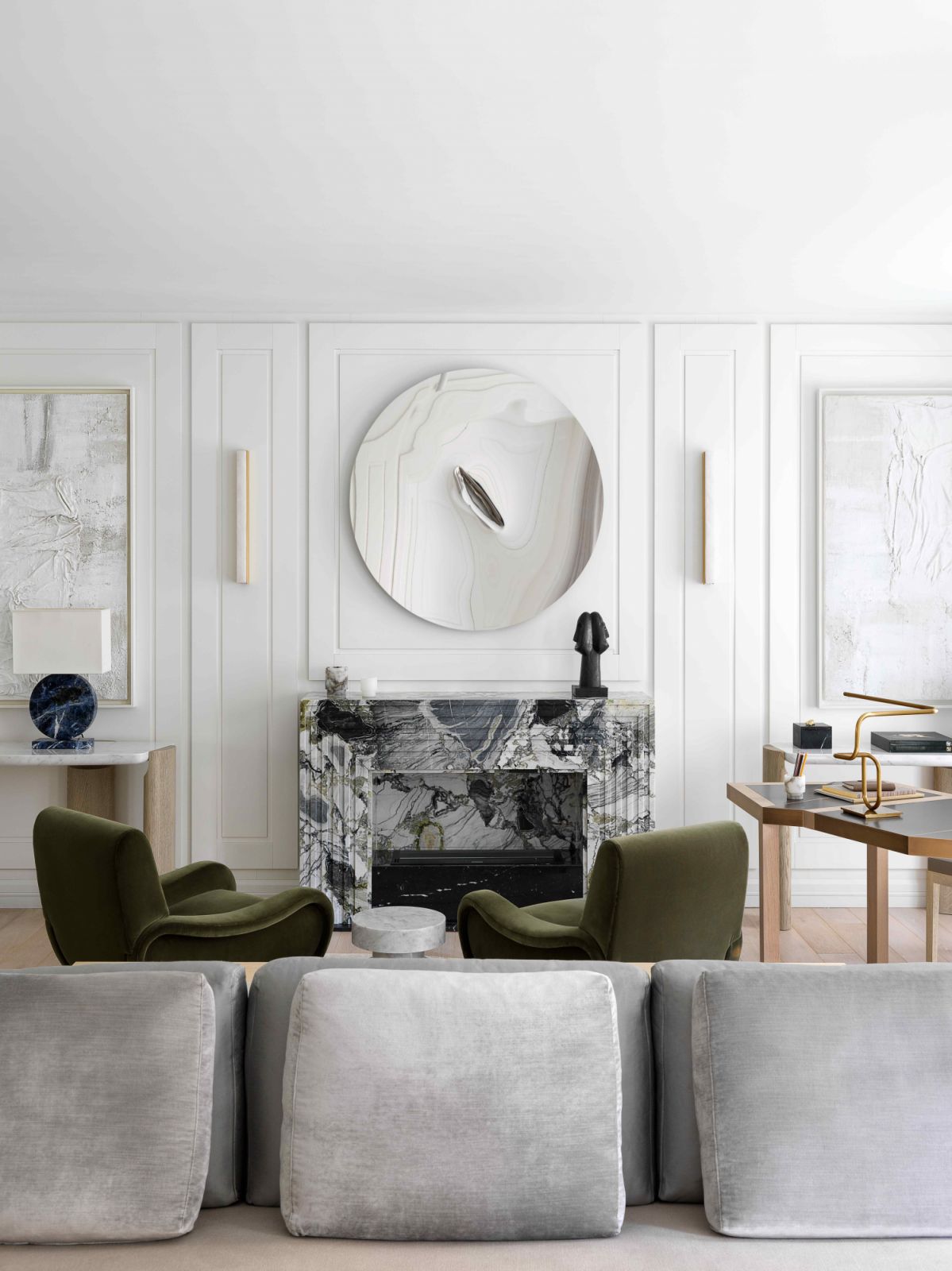 The reflective sculpture by John Franzen suspended above the fireplace
