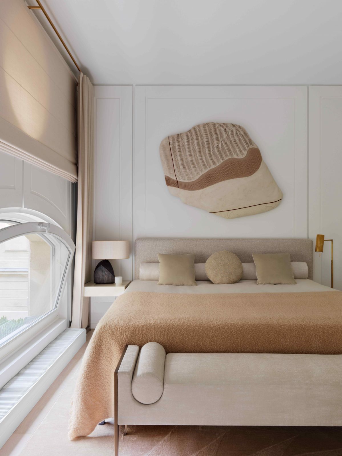 The master bedroom is imbued with beige and cream tones
