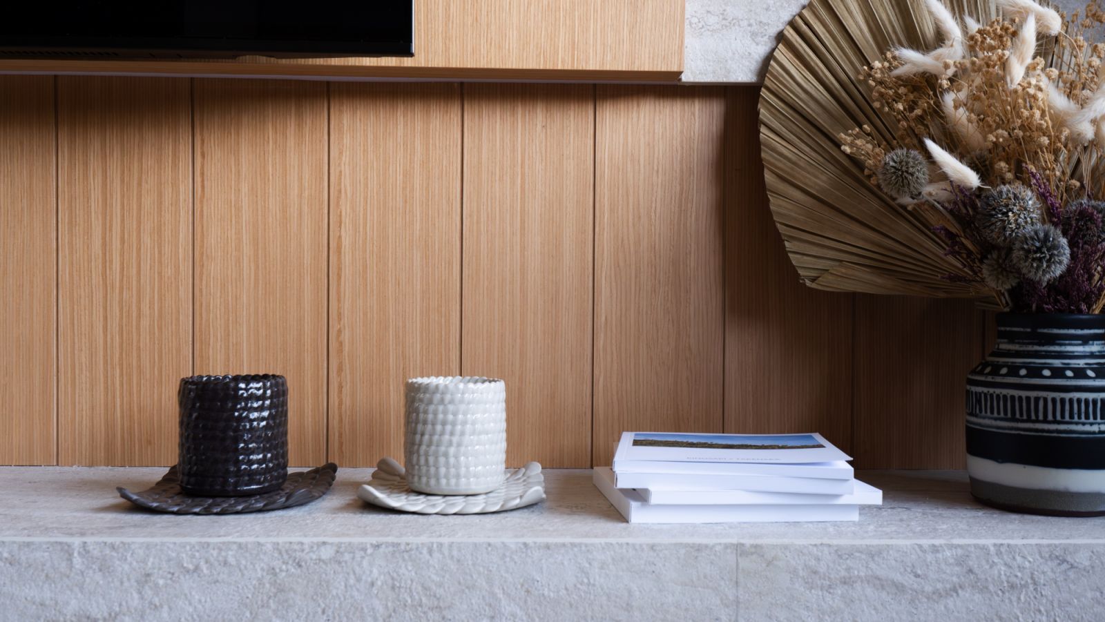From the grooved timber cladding to hand-glazed ceramics, the interior champions a quiet rhythm of layered materiality