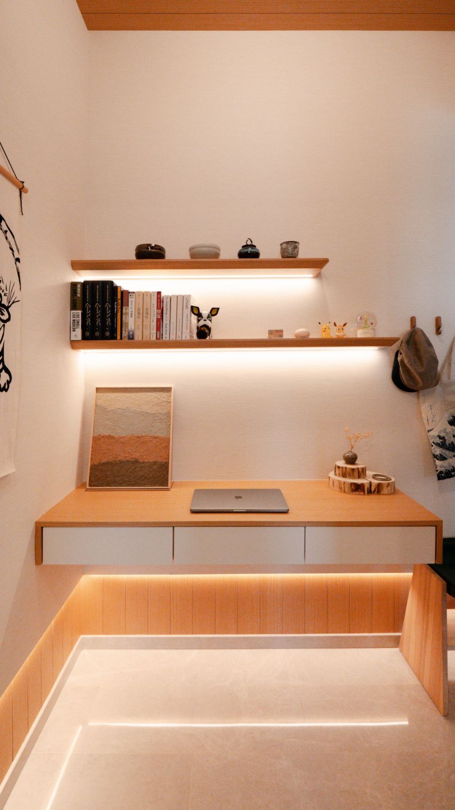 A compact study corner is elevated with layered lighting, curated books, and a minimalist palette that encourages calm focus