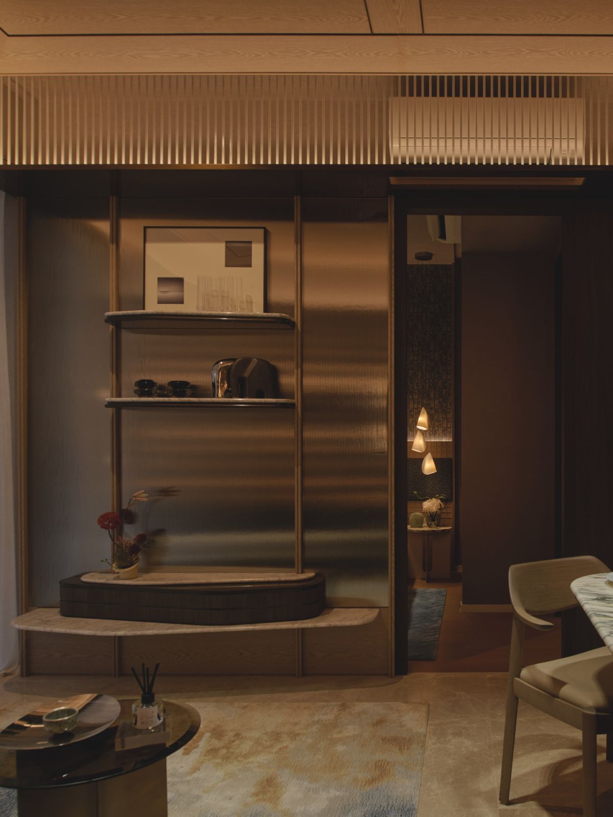 Frosted glass, sculptural details, and soft curves combine in this quiet alcove to enhance the residence’s gentle, ocean-inspired ambience