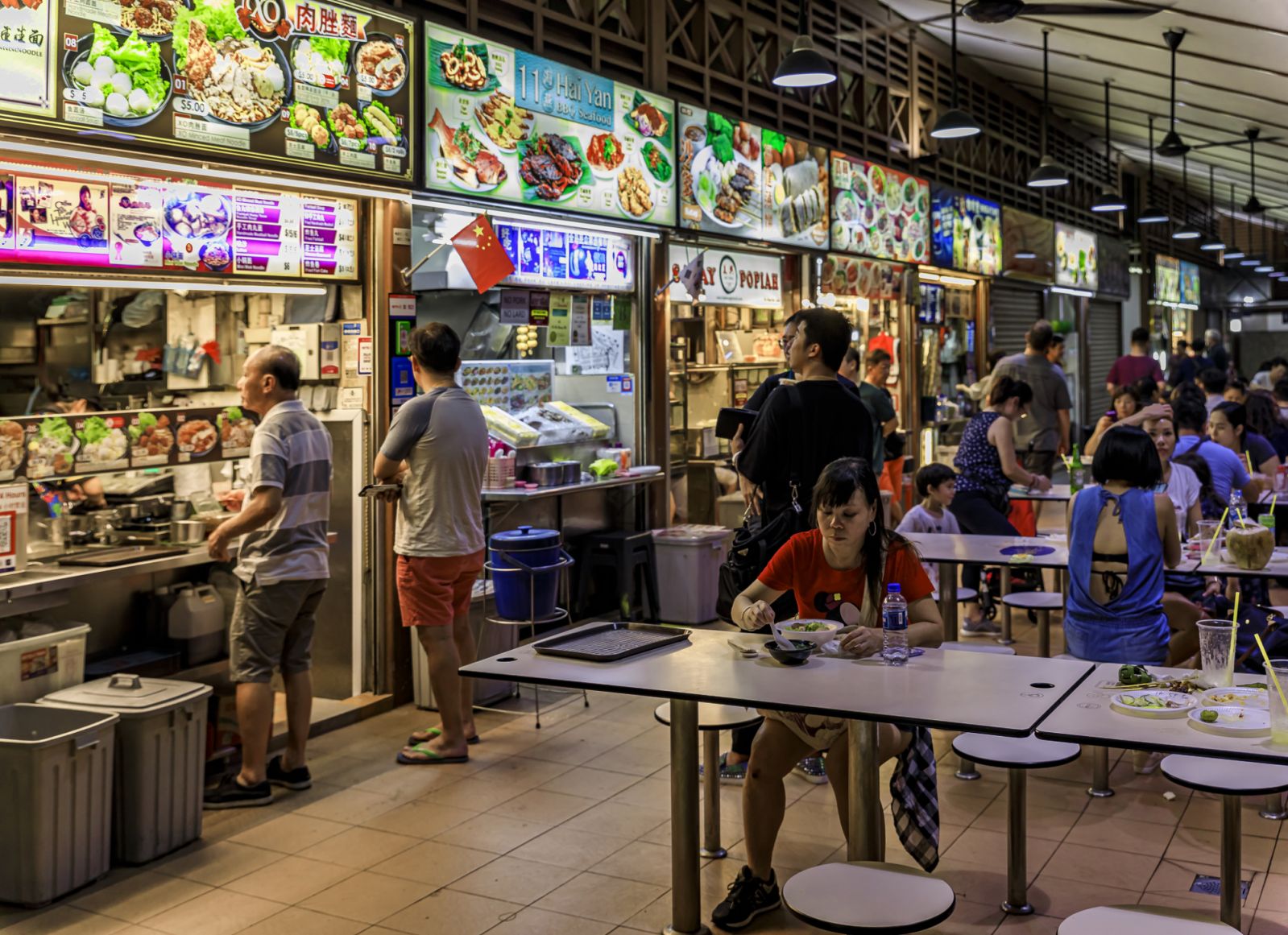 Singapore - September 07, 2019: Locals and tourists, customers walking through and eating at the street hawker center in Lau Pa Sat Telok Ayer Market