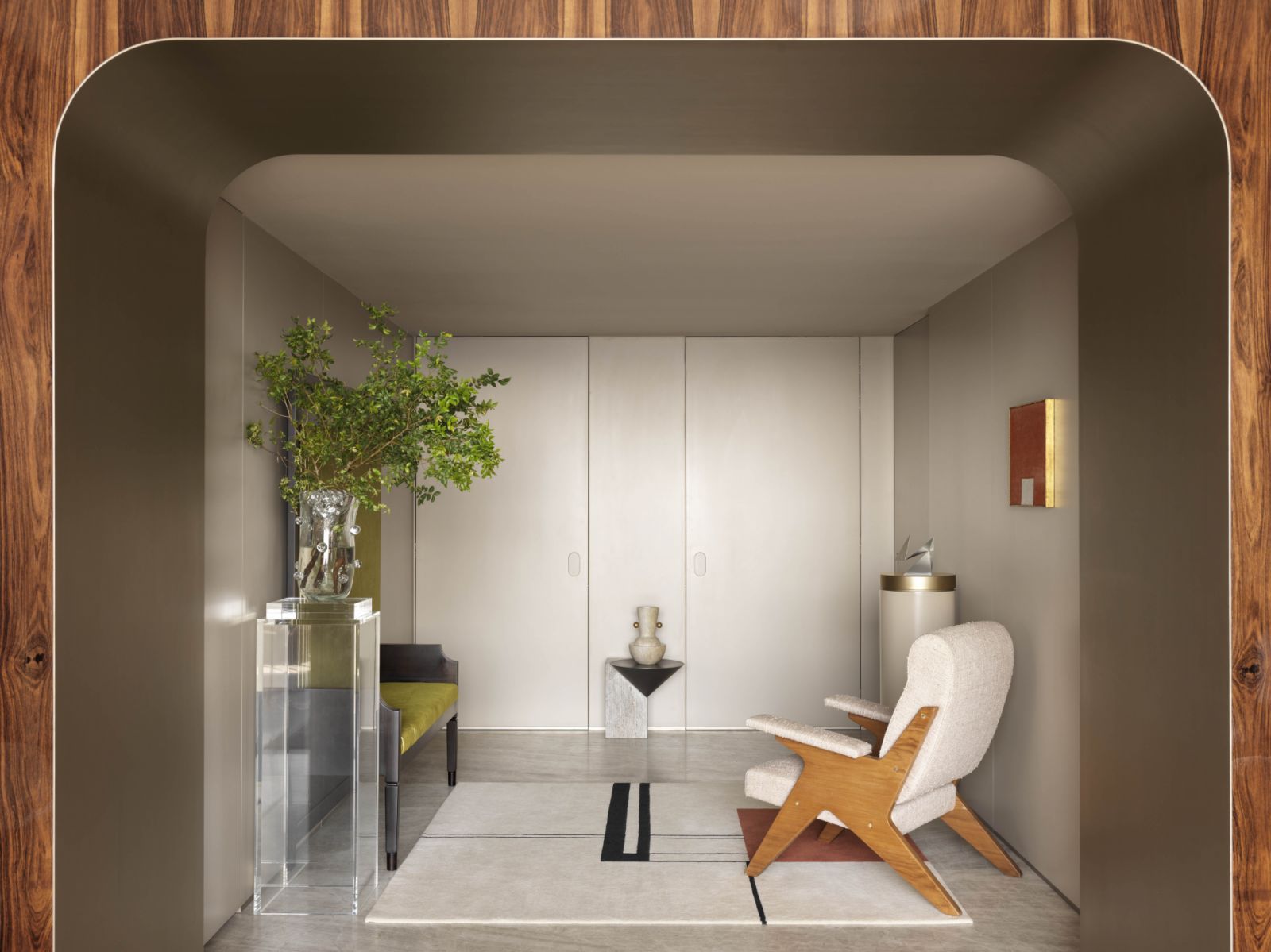 In the entryway, a vintage armchair by Lina Bo Bardi and Giancarlo Palanti anchors a composition featuring Eileen Gray’s reissued Wendingen Rug, a painting by Milton Dacosta and an acrylic stand by Gomide & Marzano