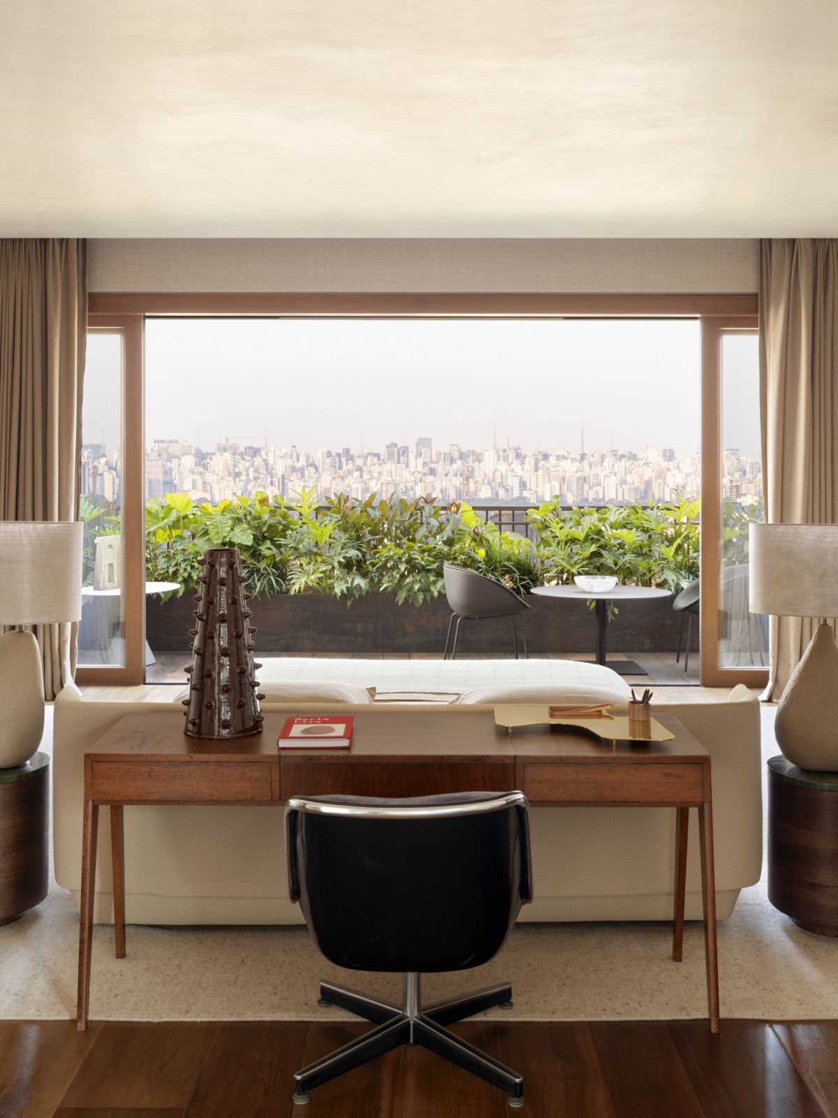 A brass tray from Etel, Cactos vase by Giacomo Tomazzi, vintage desk by Joaquim Tenreiro and Knoll chair by Charles Pollock feature in this study corner