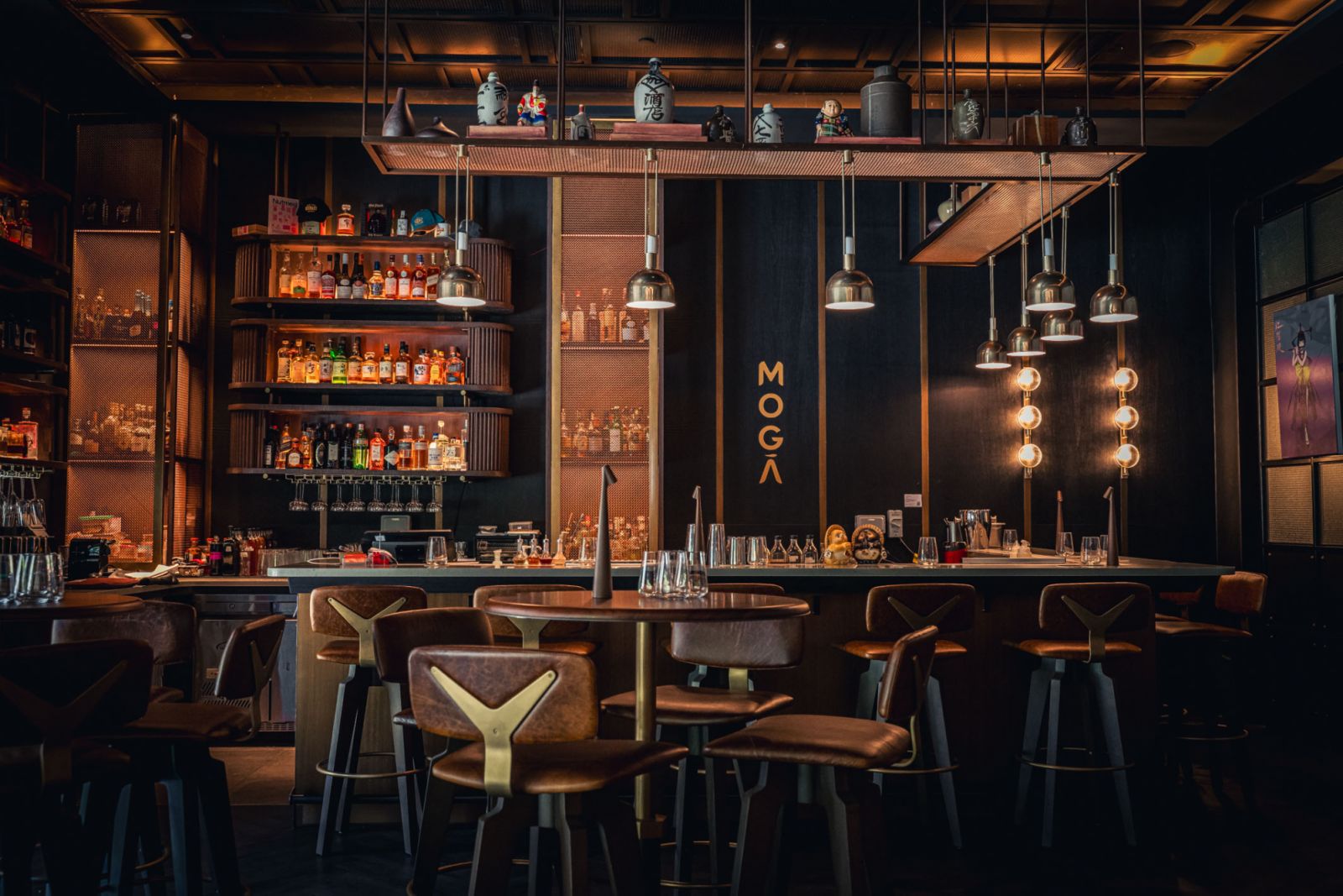 MOGA’s spirited personality is reflected in every detail—from the sleek brass accents to the meticulously curated spirits lining its backlit bar
