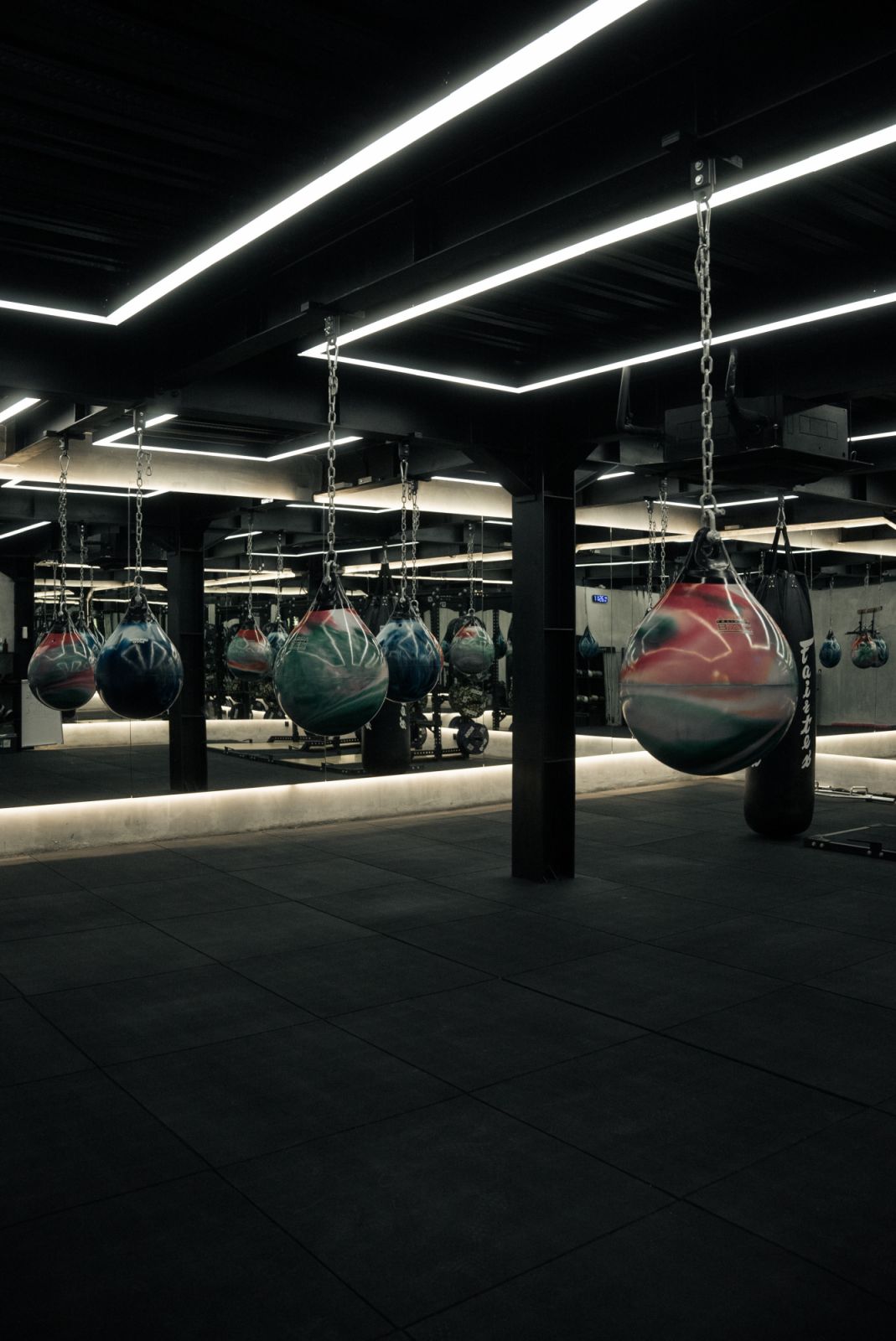 Punching bags painted in swirling colours