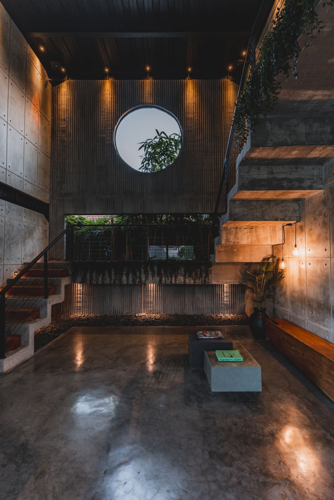 A minimalist blend of concrete, steel and greenery defines the architectural language of Wrong Gym’s central stairwell
