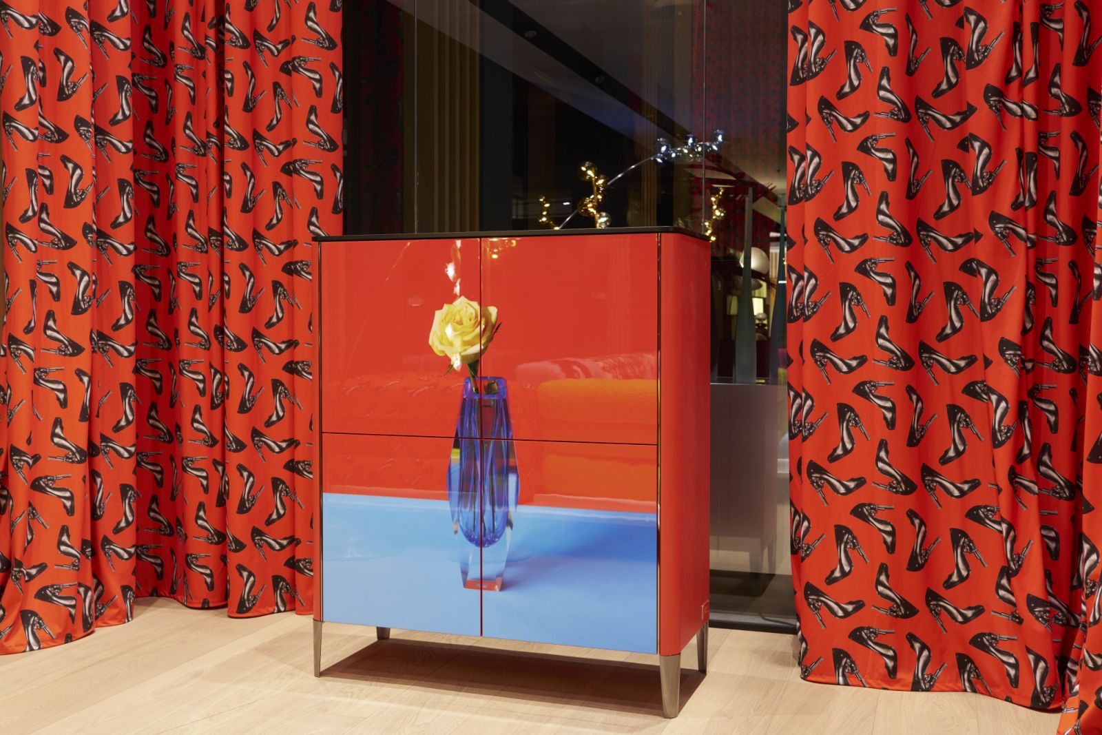 Stiletto-patterned curtains and the graphic finish of the sideboard create a striking vignette in this corner of the Roche Bobois showroom