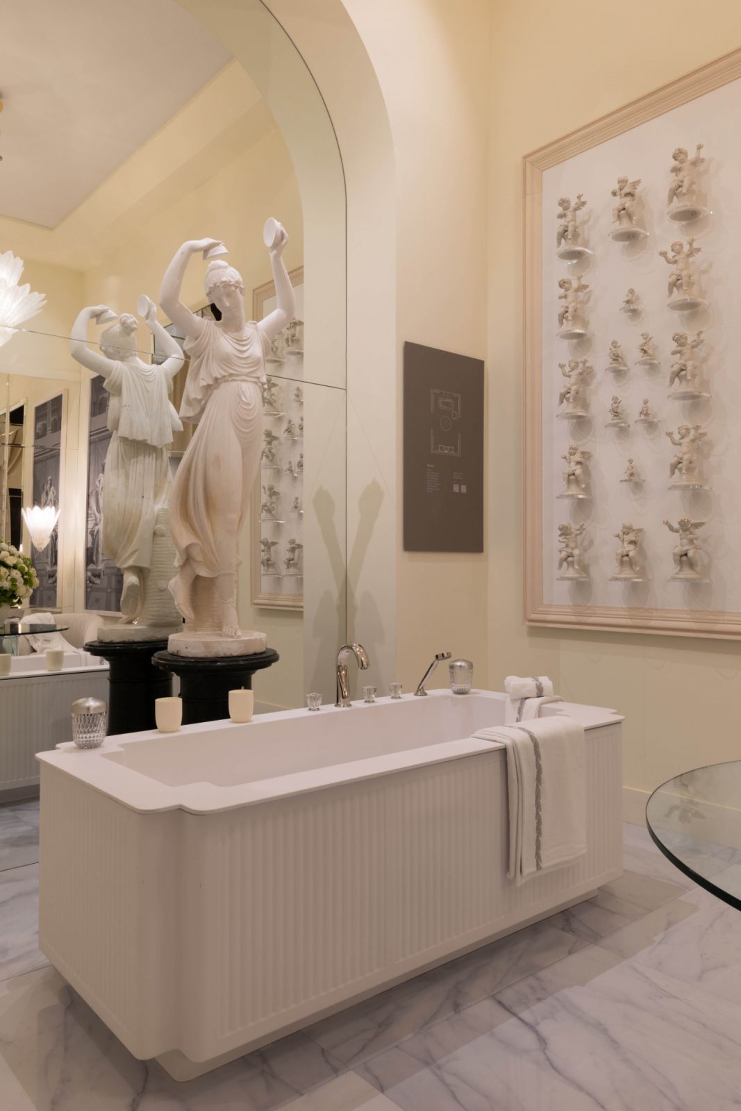 A cream-toned bath, dressed in elegant stone and classical statuary, evoked the quiet grandeur of a bygone era
